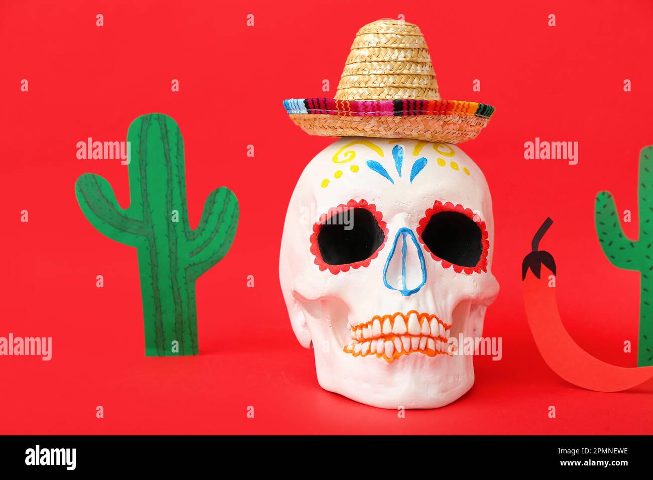 Painted skull with sombrero hat, paper cacti and chili pepper on red ...