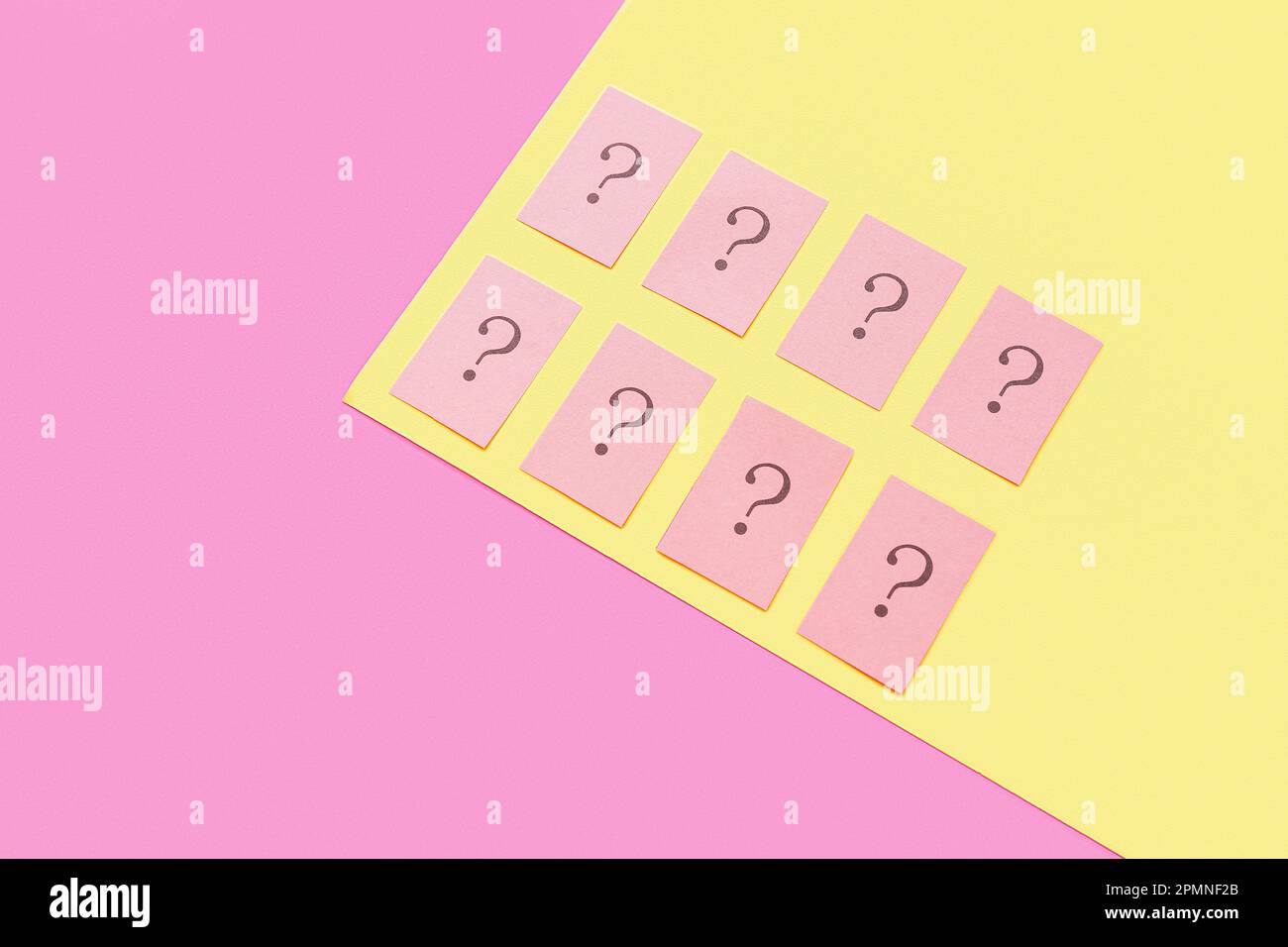 Papers with question marks on color background Stock Photo - Alamy