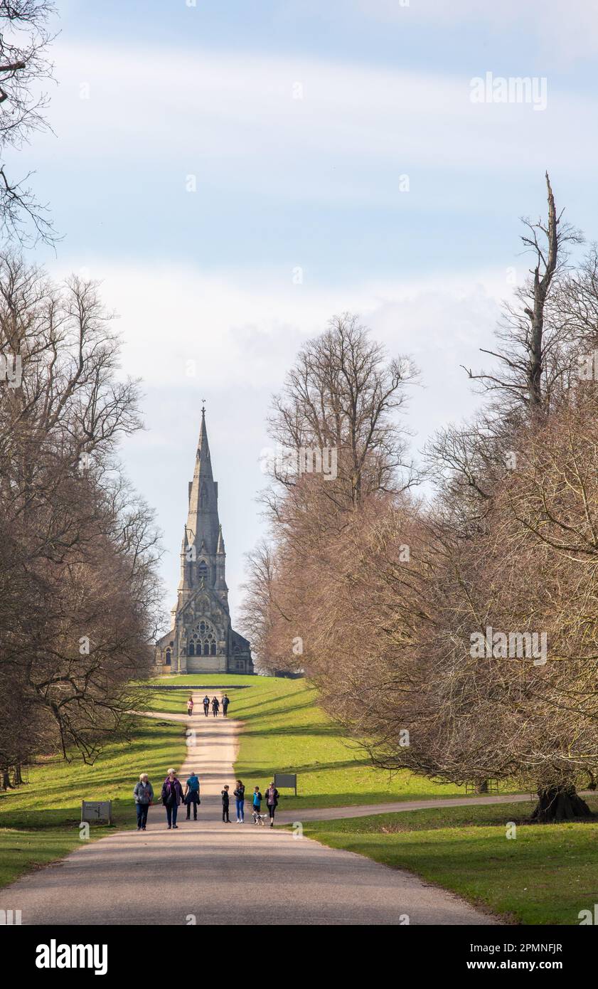 People walking in the grounds of Studley Royal Gardens with St. Mary's