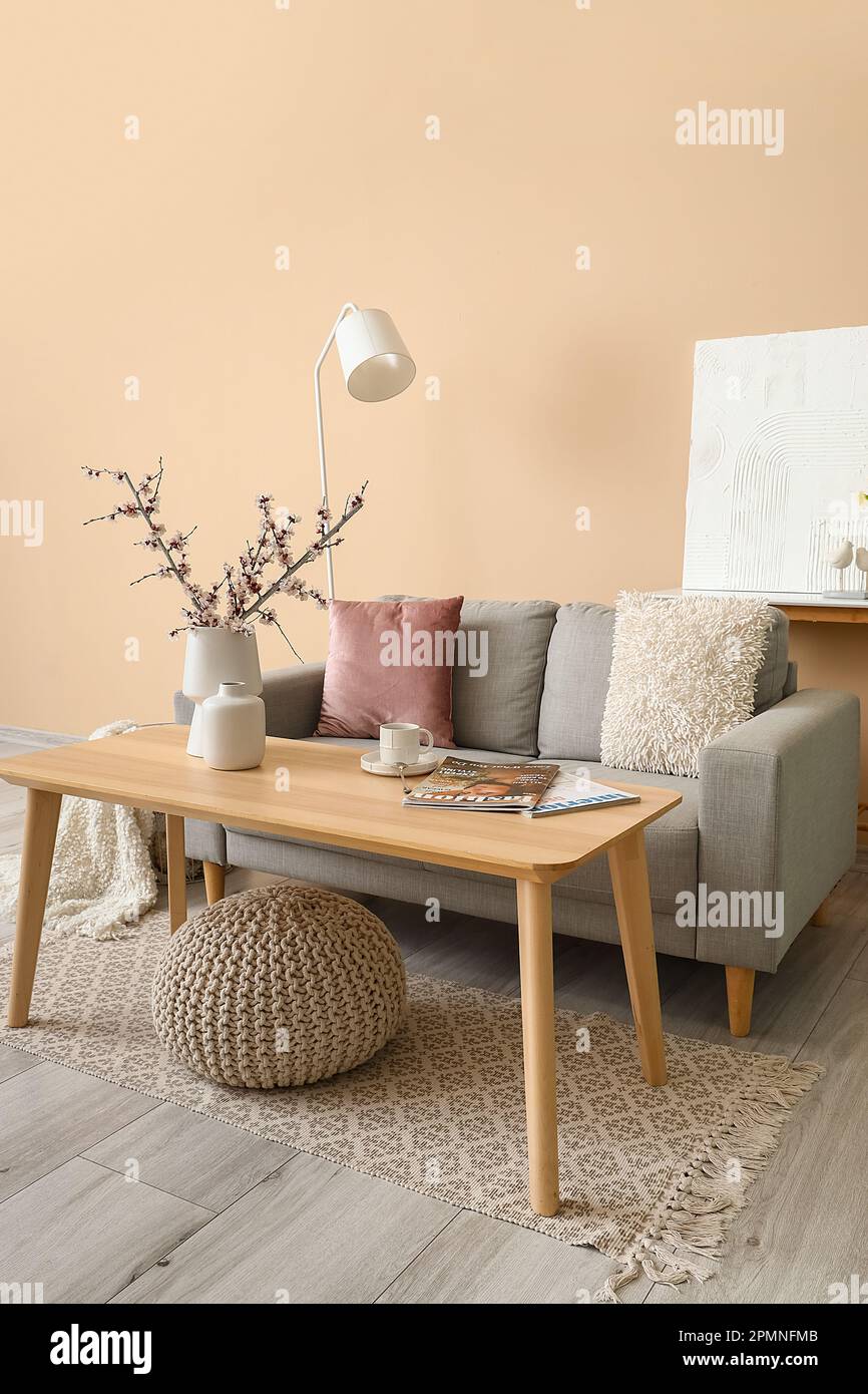 Interior of living room with grey sofa, table and lamp Stock Photo - Alamy