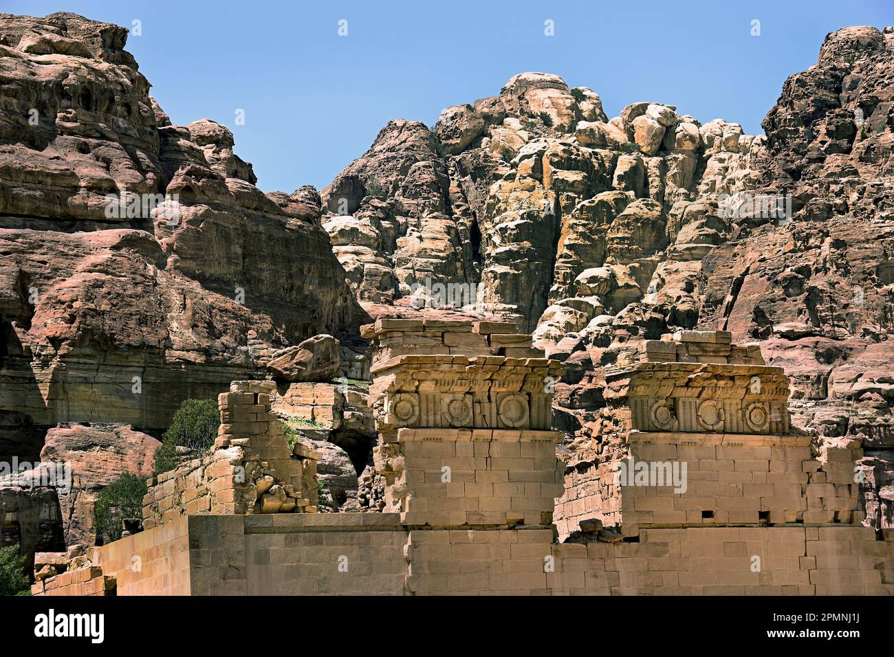 Temple of Dushares Petra city Nabataean caravan-city rock-cut façades Jordan carved sandstone rock desert. Stock Photo