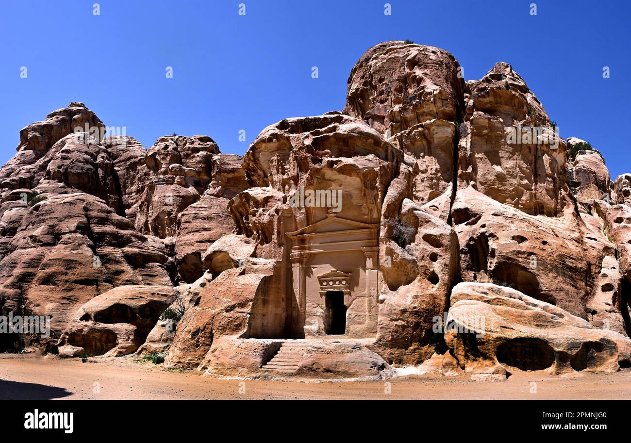 The tomb at the entrance of Al Beidha or Little Petra, Wadi Musa, Nabataean caravan-city rock-cut façades Jordan carved sandstone rock desert, Stock Photo