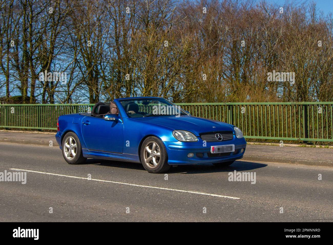 2001 Blue Mercedes Benz SLK 320  3199cc Petrol 5 speed automatic cabrio; crossing motorway bridge in Greater Manchester, UK Stock Photo
