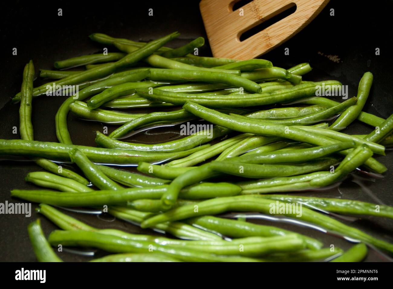 Sauteed Green Beans on the stove in oil Stock Photo Alamy