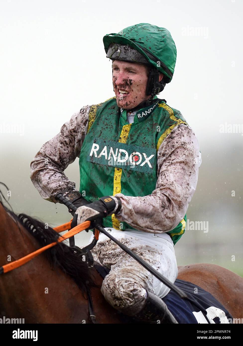 Jockey Ben Harvey covered in mud after the William Hill Handicap Hurdle on day two of the Randox Grand National Festival at Aintree Racecourse, Liverpool. Picture date: Friday April 14, 2023. Stock Photo
