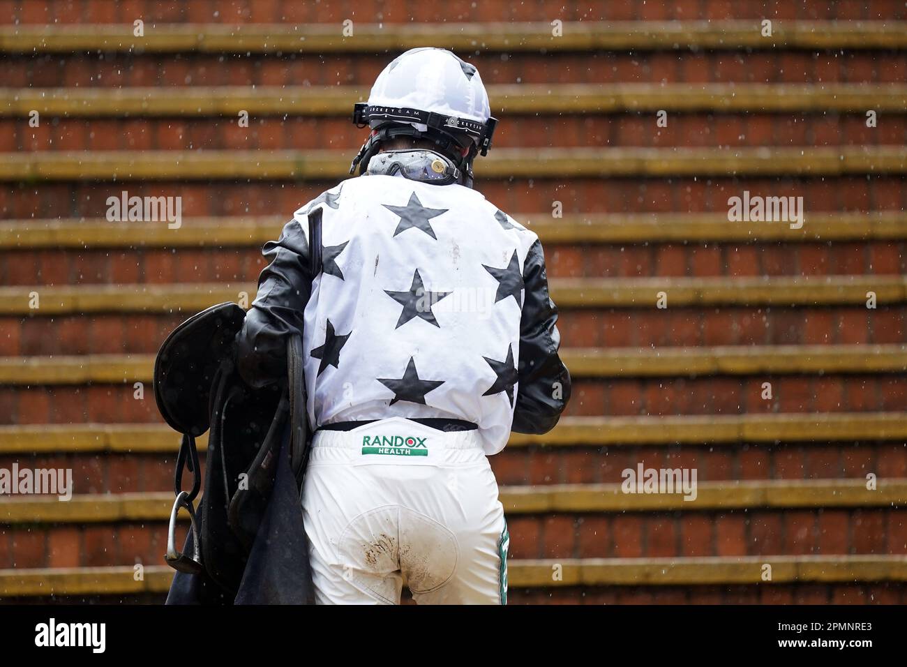 Jockeys covered in mud after the William Hill Handicap Hurdle on day two of the Randox Grand National Festival at Aintree Racecourse, Liverpool. Picture date: Friday April 14, 2023. Stock Photo