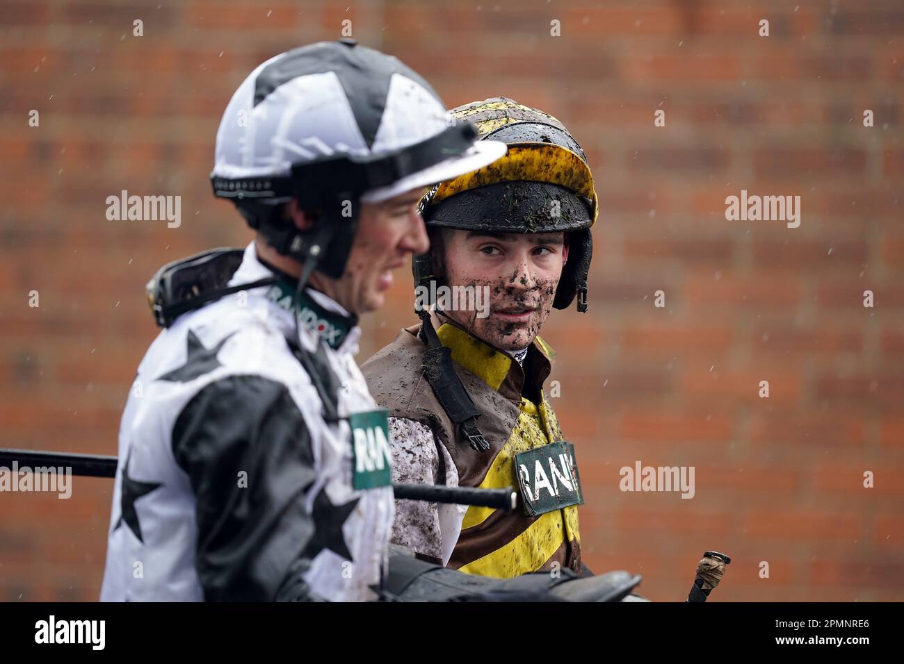 Jockeys covered in mud after the William Hill Handicap Hurdle on day two of the Randox Grand National Festival at Aintree Racecourse, Liverpool. Picture date: Friday April 14, 2023. Stock Photo