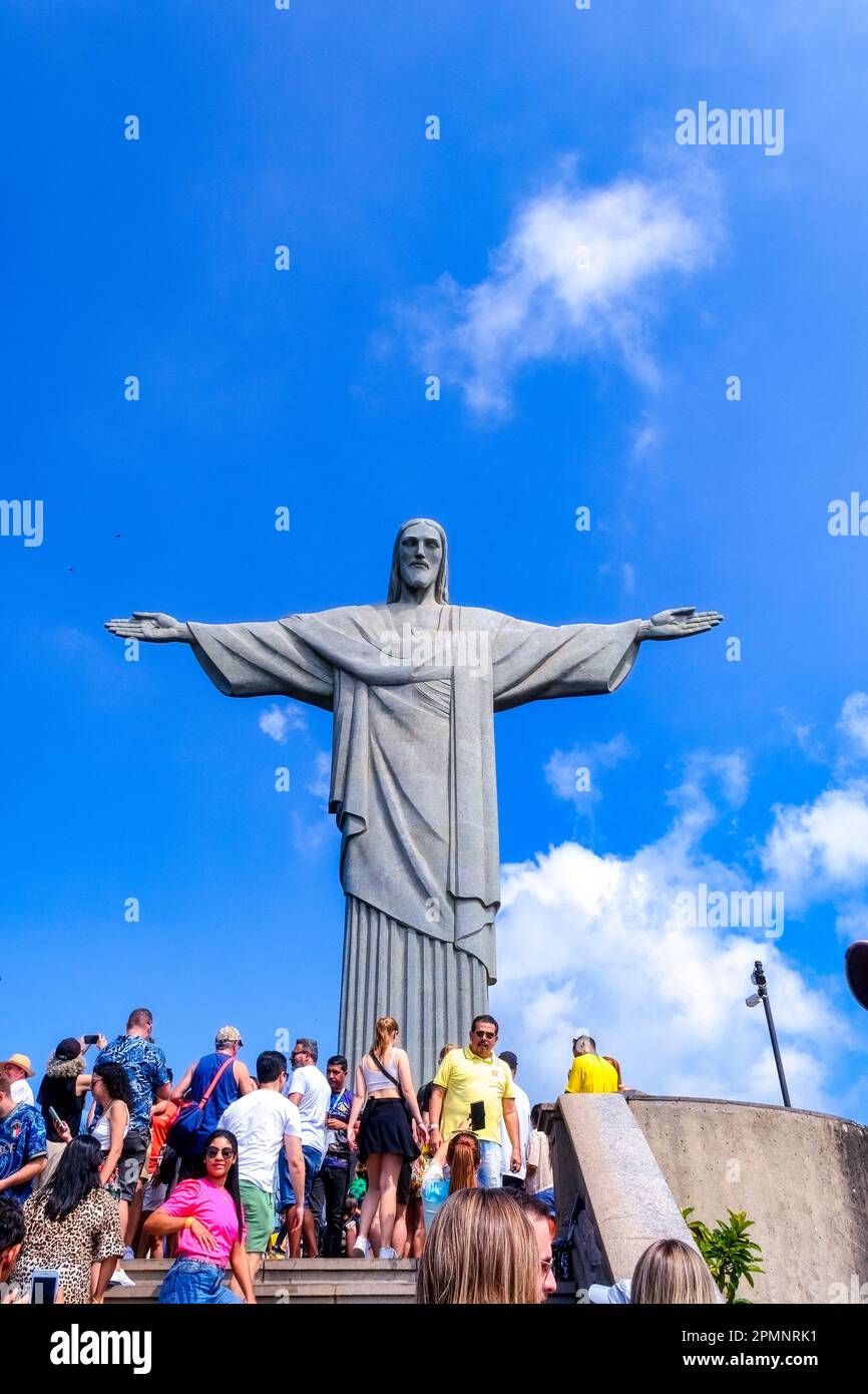 Rio de Janeiro, Brazil - April 4, 2023: Group of tourists in the Christ the Reedemer statue. The piece of art has an art-deco style. Stock Photo