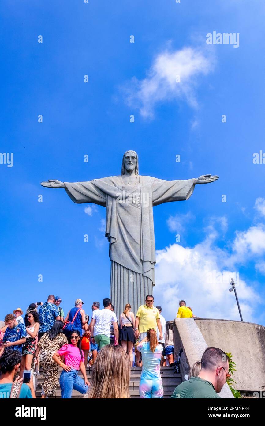 Rio de Janeiro, Brazil - April 4, 2023: Group of tourists in the Christ the Reedemer statue. The piece of art has an art-deco style. Stock Photo