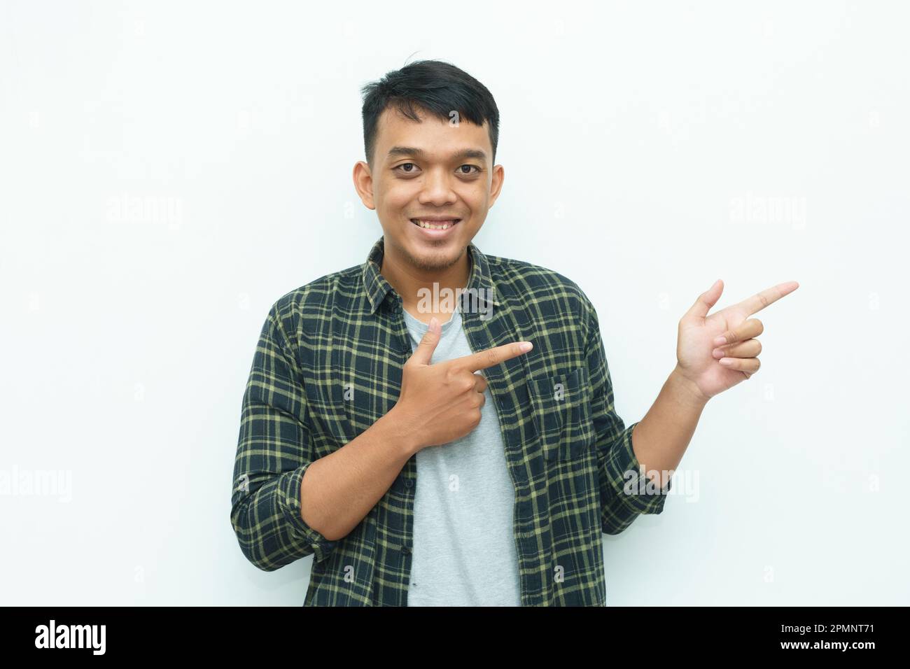 Lip Pointing Young Asian man smiling and the finger pointing to the left side with ...