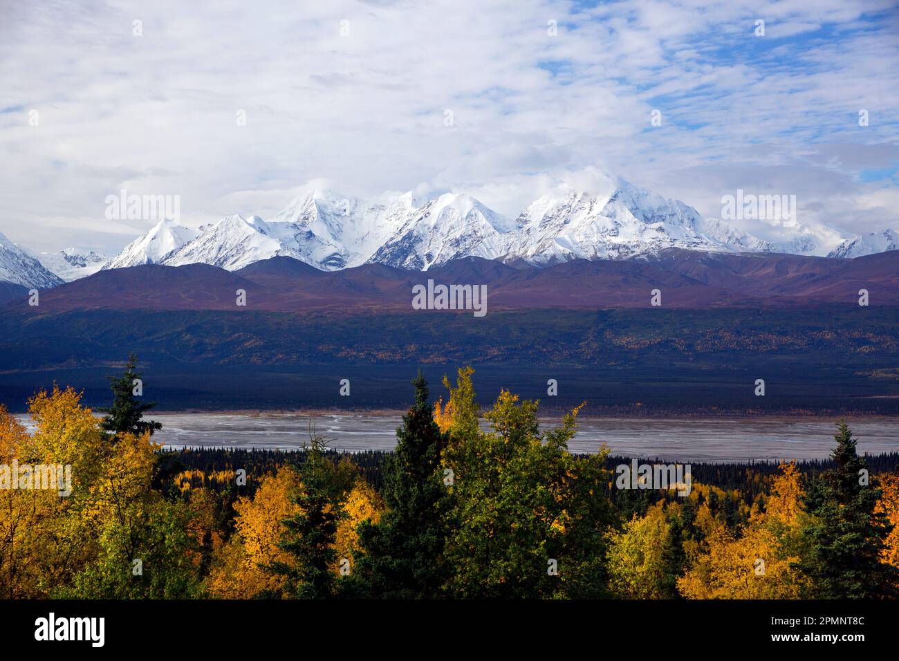 Stunning autumn view of the Rainbow Ridge Mountains with McCallum Creek in the foreground; Alaska, United States of America Stock Photo