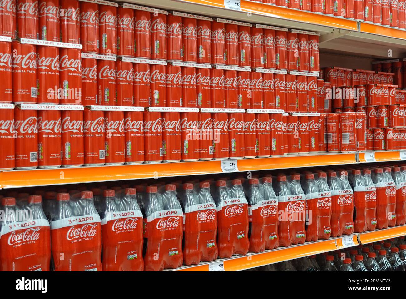 Athens, Greece - March 6, 2023: Shelves with Coca Cola soft drink cans and bottles in economy size packs. Stock Photo