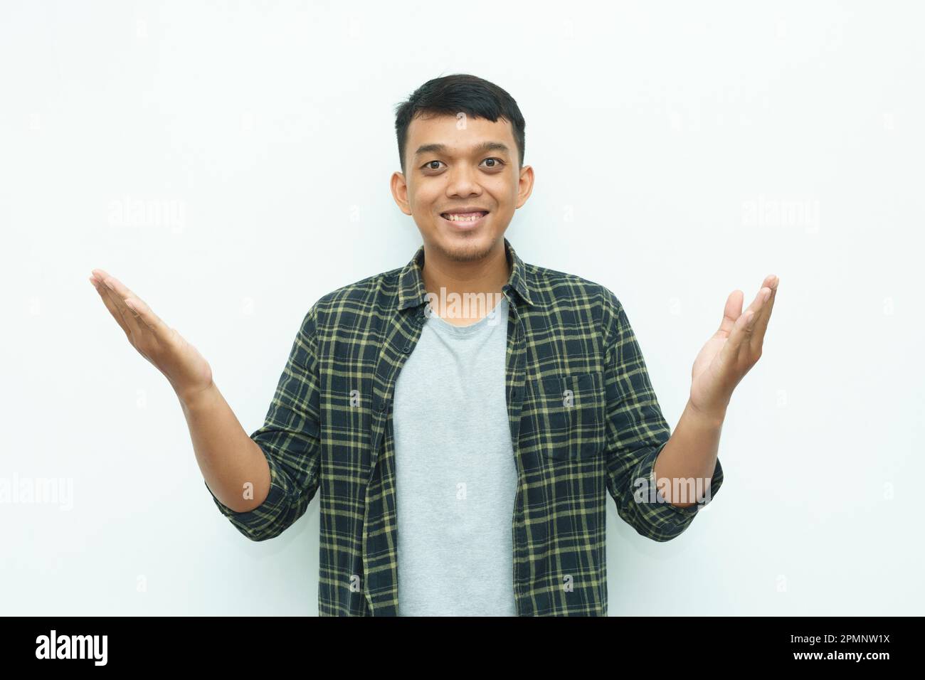 Young Asian man smiling while put hand palms in front of his body for ...