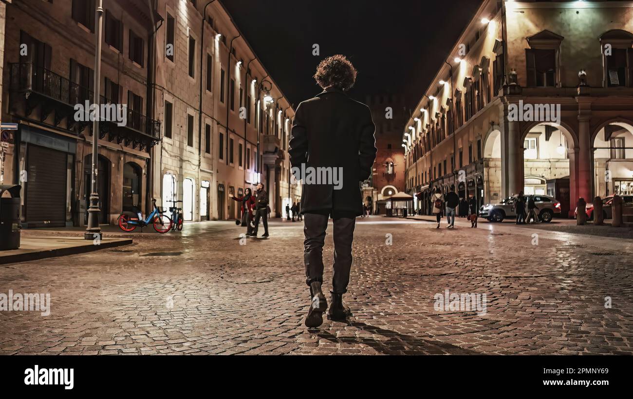 his photo captures the silhouette of a young man walking down a city ...