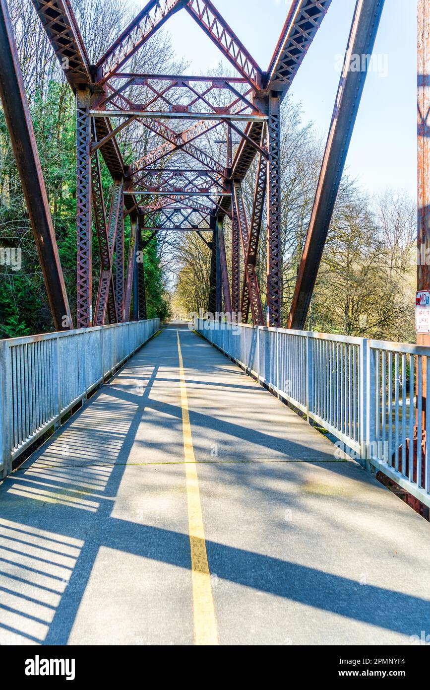 A bridge with rusty trestles along the Cedar River Trail in Renton, Washington. Stock Photo