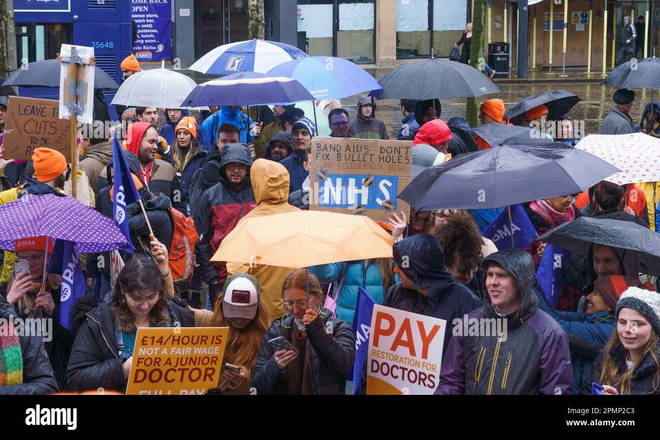 Leeds, UK, 14th April 2023.  Despite the periods of heavy rain junior doctors from the Yorkshire region gather in the city centre at the end of four continual days of strike to demand pay restoration from government. The mood was defiant, with talk of plans for future strikes. The Health Secretary and Chancellor both continue to hold the line against talks until the BMA reduce their demands. Bridget Catterall/AlamyLiveNews Stock Photo