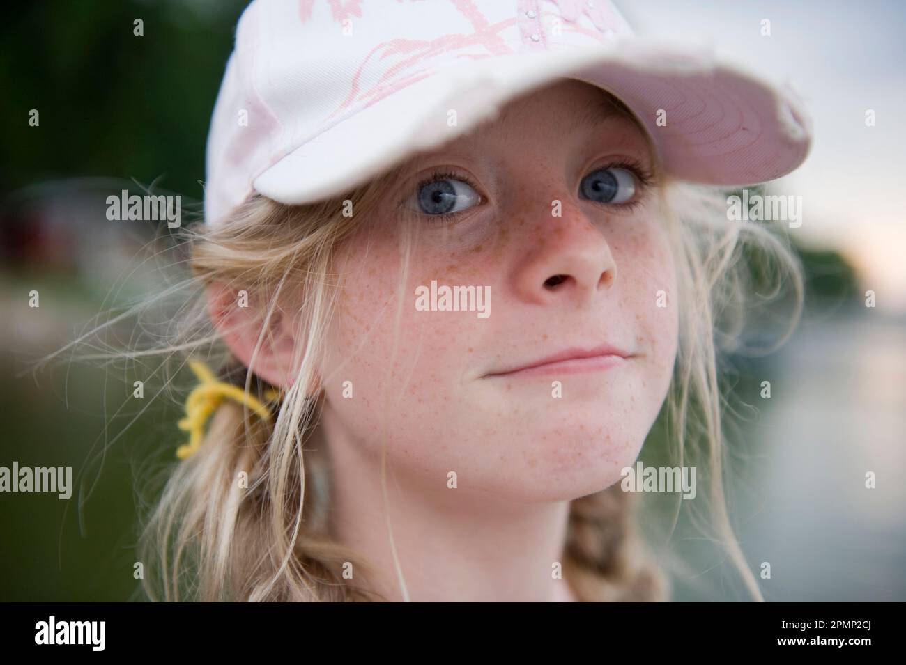 Close-up portrait of a young girl with freckles and blue eyes; Walker, Minnesota, United States of America Stock Photo