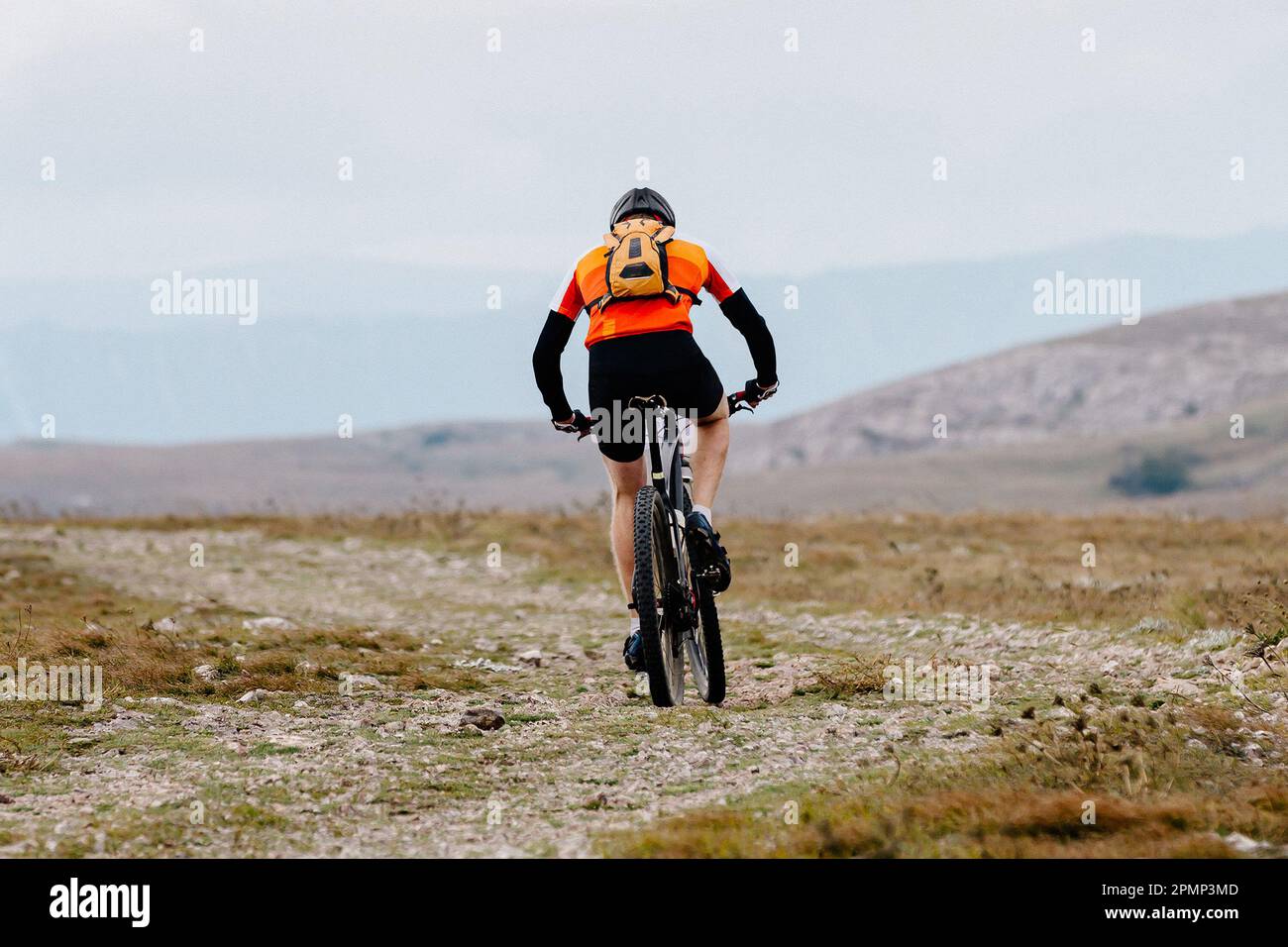 mountainbiker riding sports cycle on mountainous trail in crosscountry
