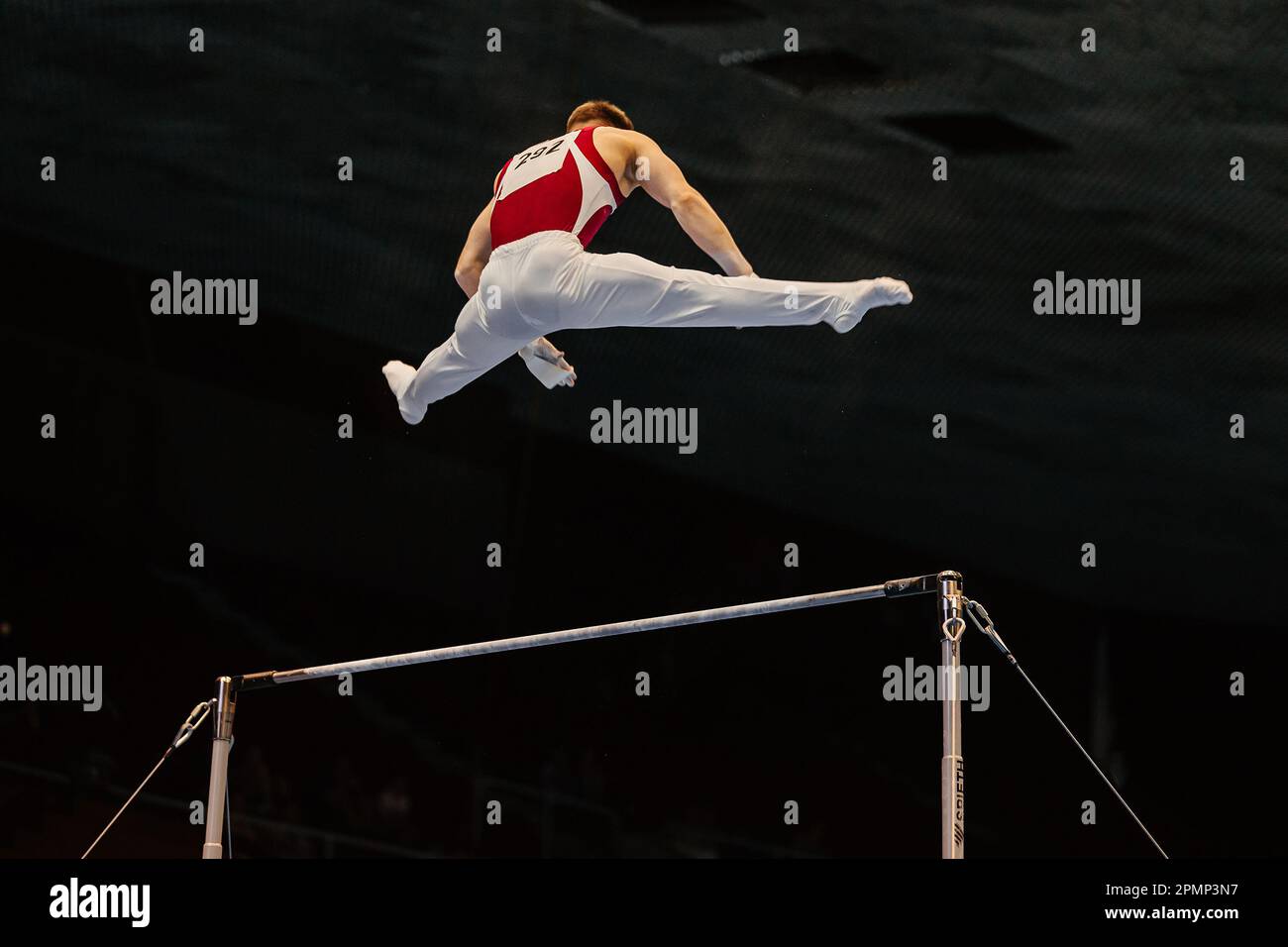 male gymnast exercise on horizontal bar in artistic gymnastics