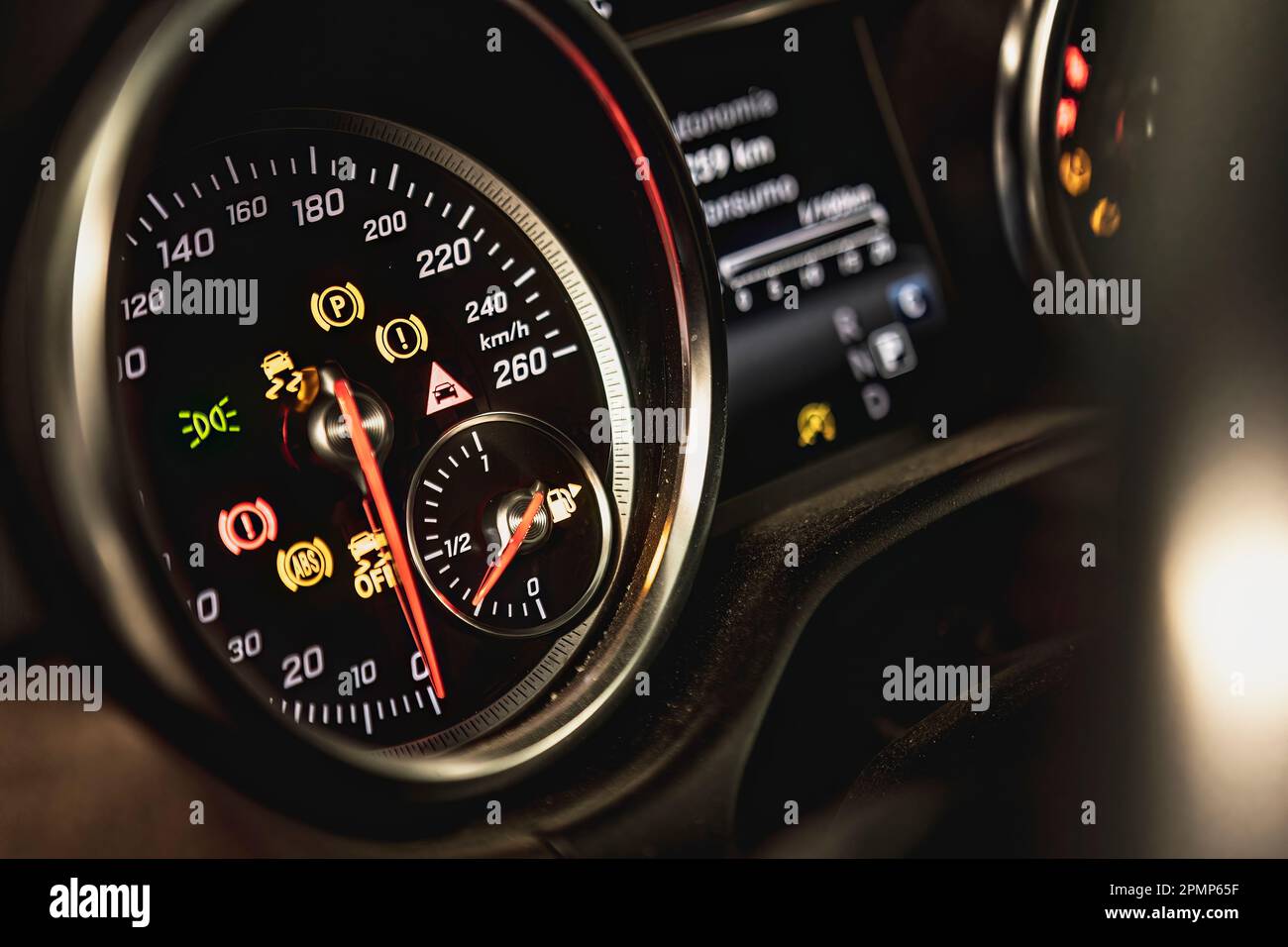 Closeup of a car dashboard with illuminated warning lights indicating