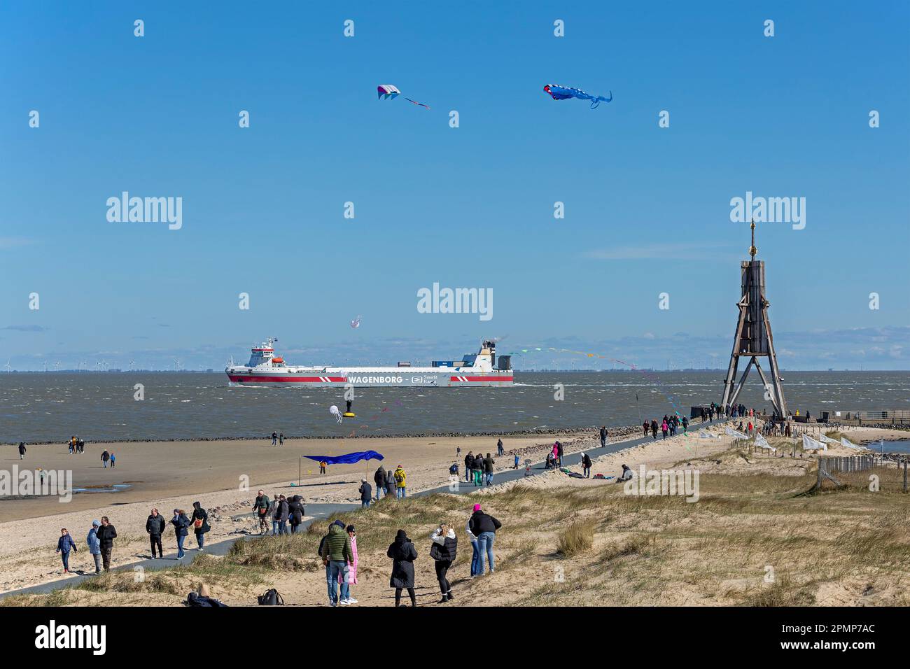 People, flying kites, freight ship, sea marker Kugelbake, North Sea, Elbe, Cuxhaven, Lower-Saxony, Germany Stock Photo
