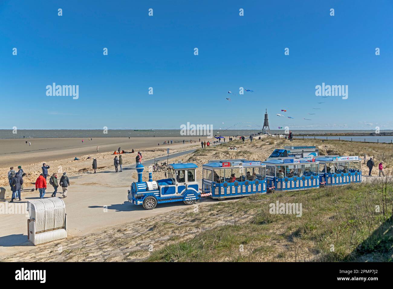 Jan  Cux beach train, people, beach  chair, flying kites, sea marker Kugelbake, North Sea, Elbe, Cuxhaven, Lower-Saxony, Germany Stock Photo