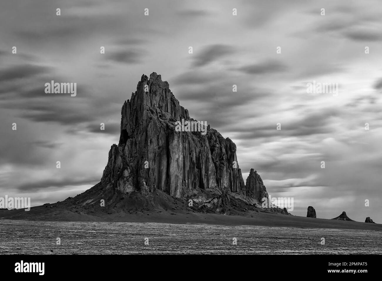 Black and white image of Shiprock in the highdesert plain of the