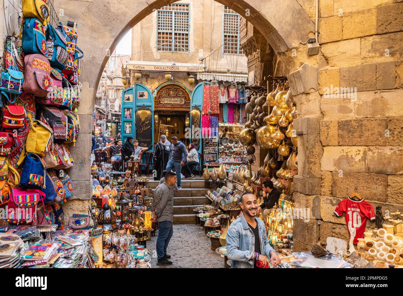 People walking through a busy Khan el-Khalili market bazaar in Islamic Cairo in Cairo, Egypt Stock Photo