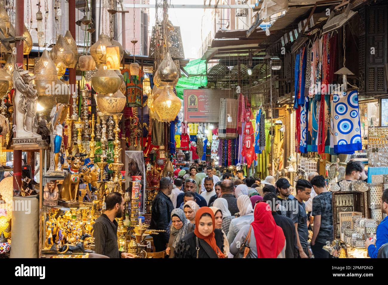 People walking through a busy Khan el-Khalili market bazaar in Islamic Cairo in Cairo, Egypt Stock Photo