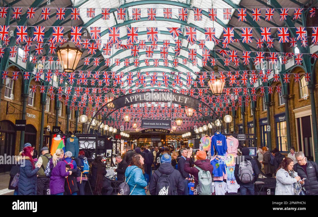 London, UK. 14th April 2023. Thousands of Union Jacks decorate Covent Garden Market as preparations for the coronation of King Charles III, which takes place on May 6th, continue around London. Stock Photo