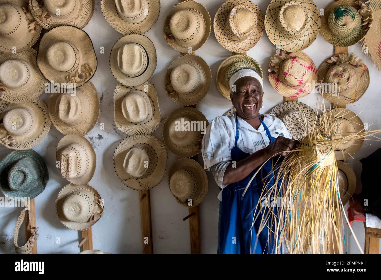 Portrait of a woman making straw hats in Trinidad, Cuba; Trinidad, Cuba Stock Photo