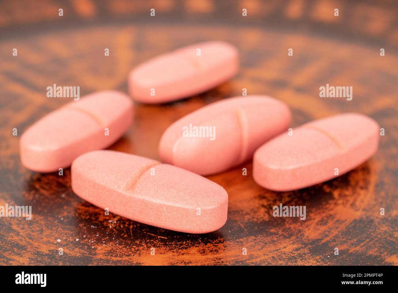 Several medical pills on a clay dish, macro. Stock Photo