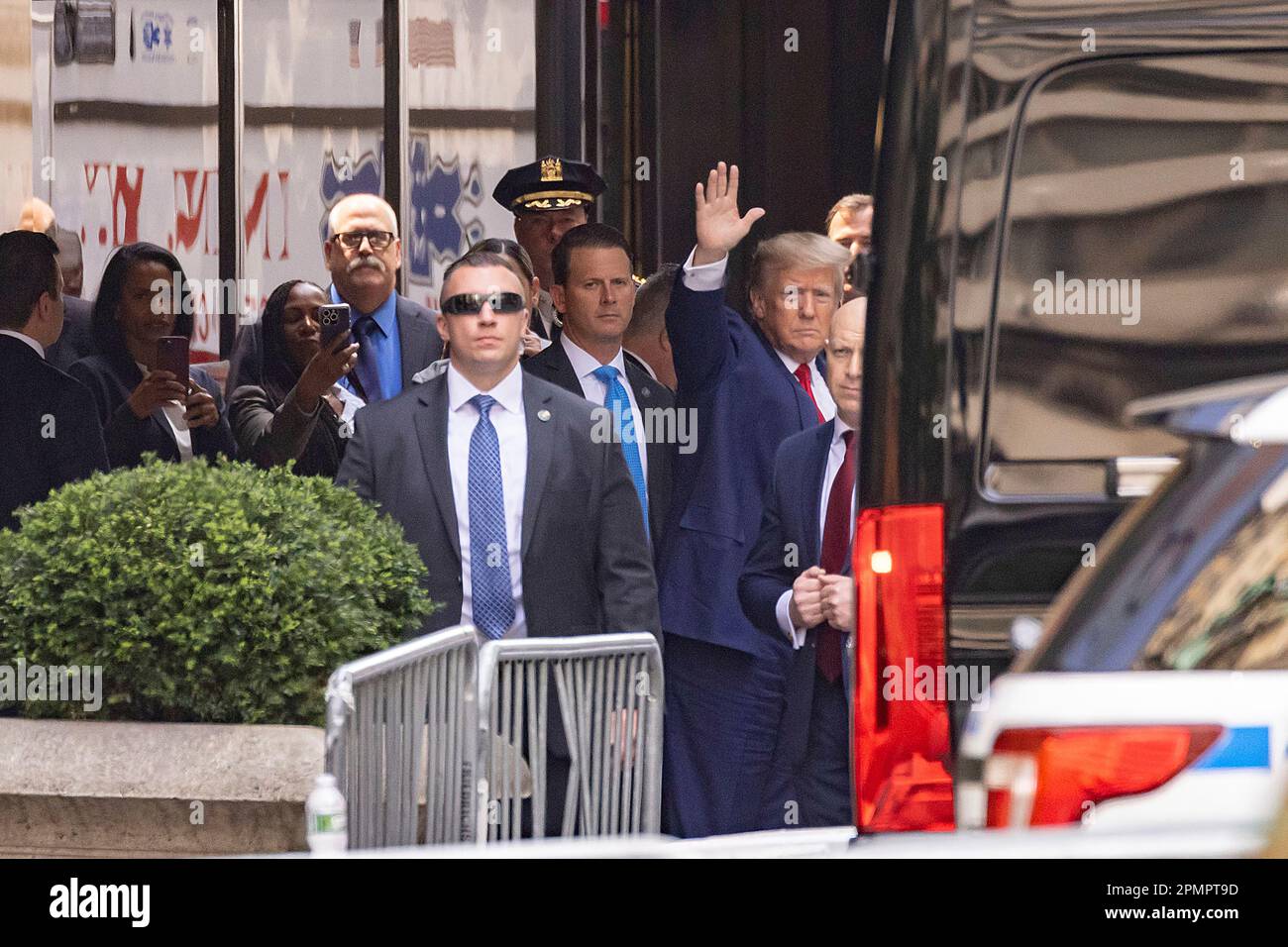 Former President Donald Trump waves as he leaves Trump Tower in New ...