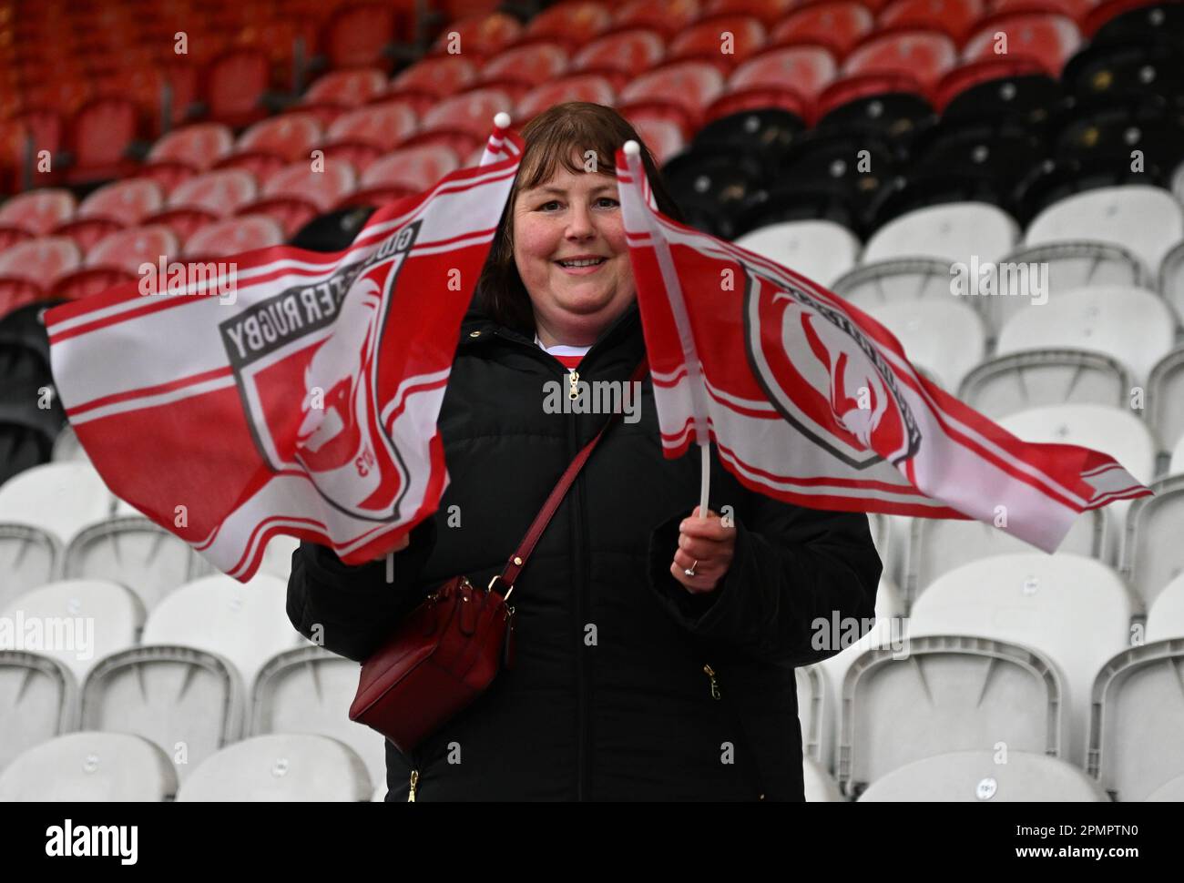 Kingsholm Stadium, Gloucester, Gloucestershire, UK. 14th Apr, 2023. Gallagher Premiership Rugby, Gloucester versus Bath; a Gloucester fan waves flags before kick off Credit: Action Plus Sports/Alamy Live News Stock Photo