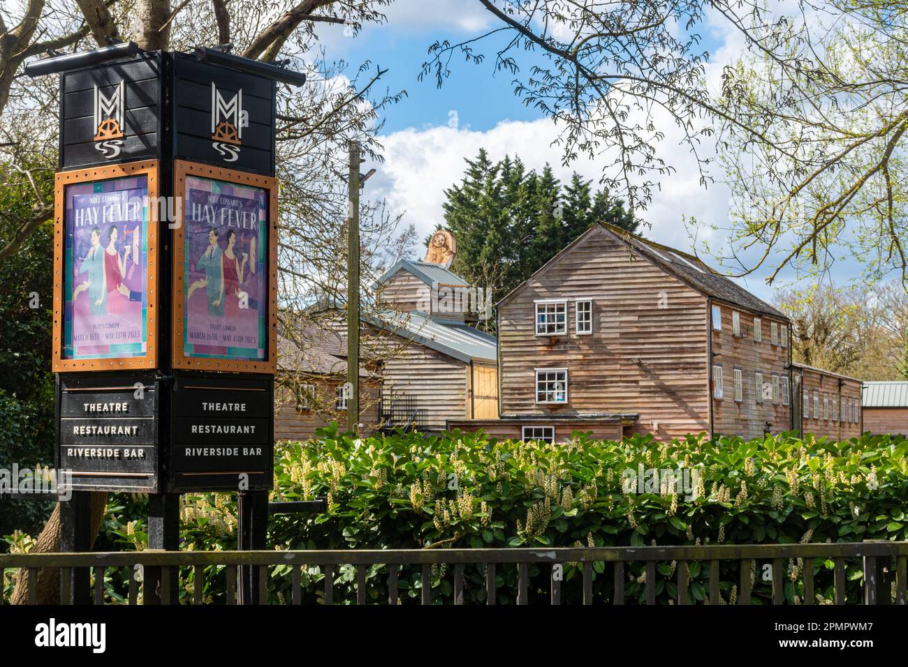 The Mill at Sonning-on-Thames, a former mill housing a theatre and restaurant, Berkshire, England, UK, with advert for Noel Coward's comedy Hay Fever Stock Photo