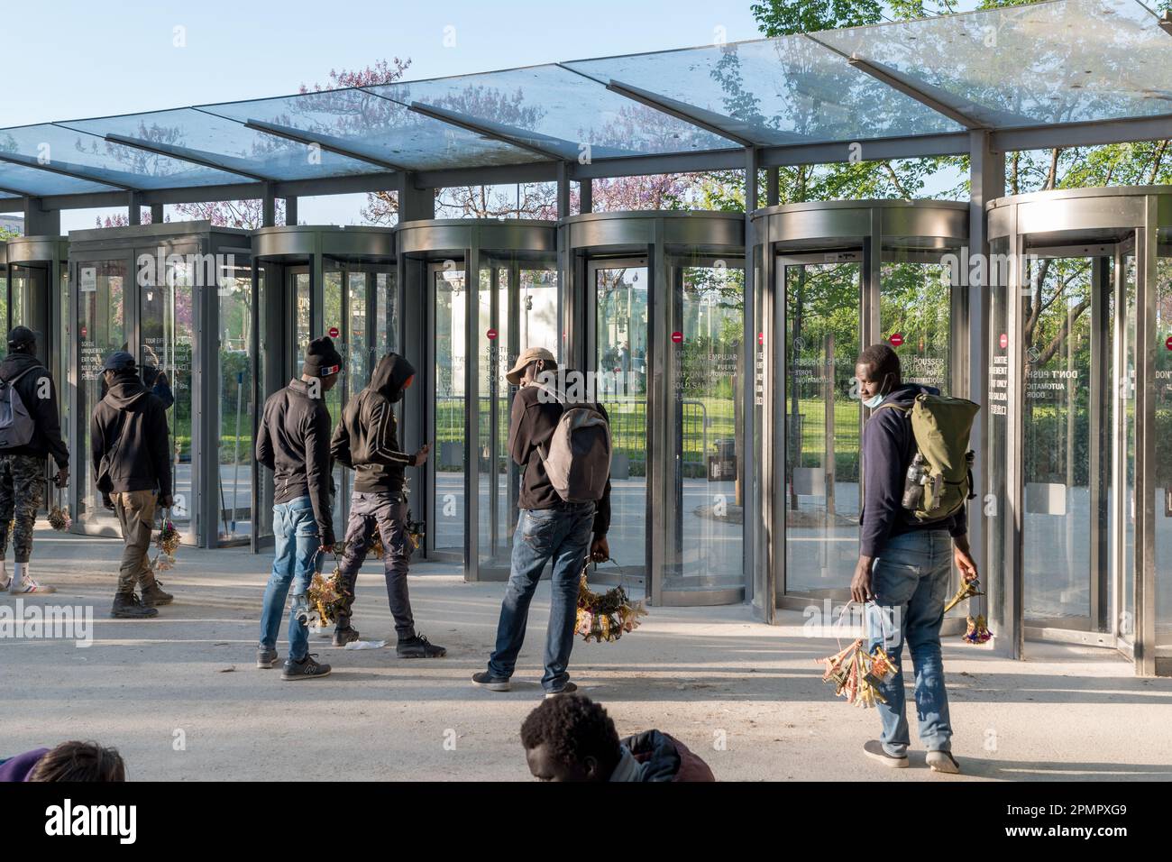 Different seller waiting around the Eiffel tower for tourists to sell souvenirs. Stock Photo