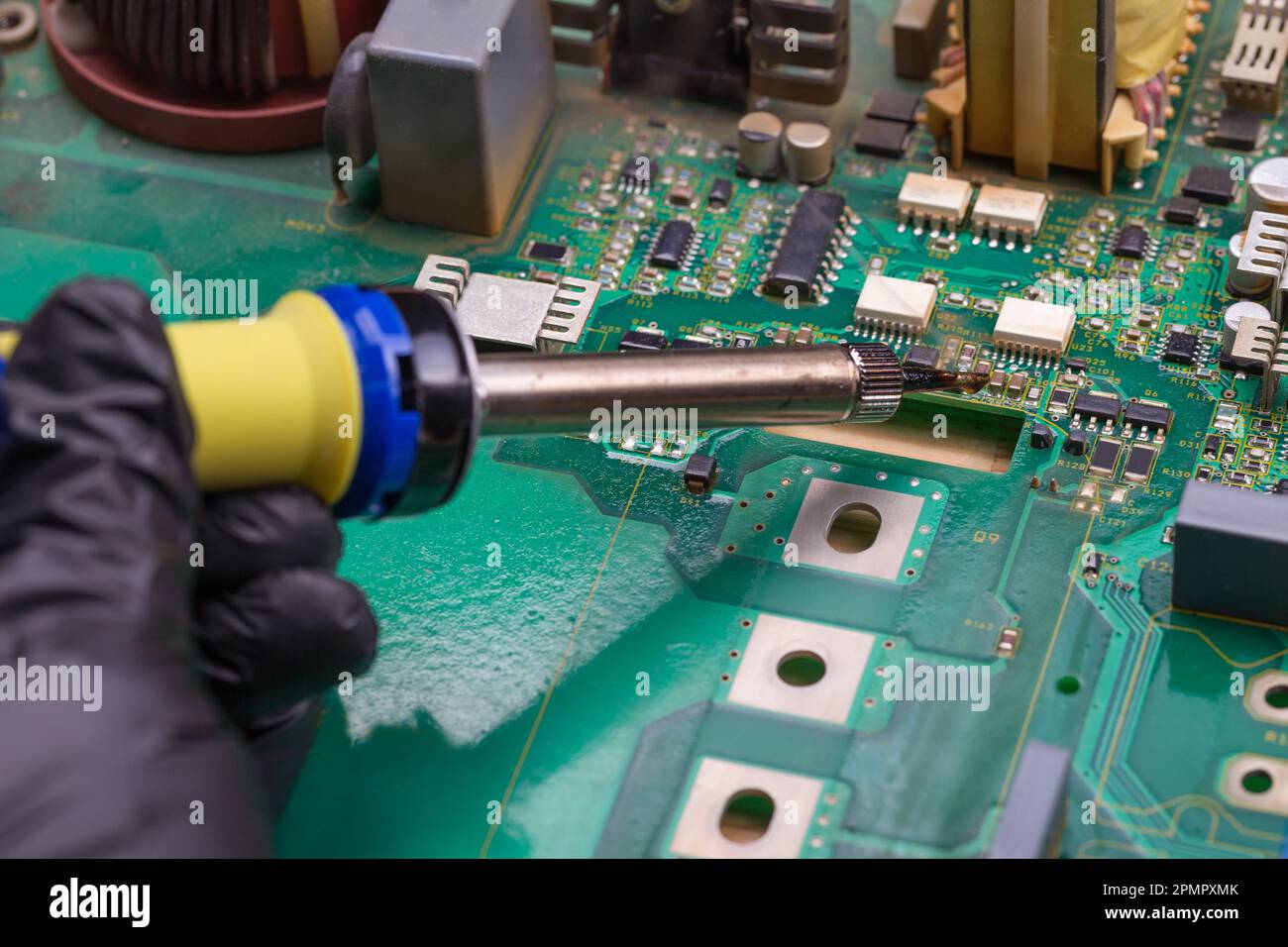 Soldering iron. Repairing electronic component. Microelectronics engineering concept Stock Photo