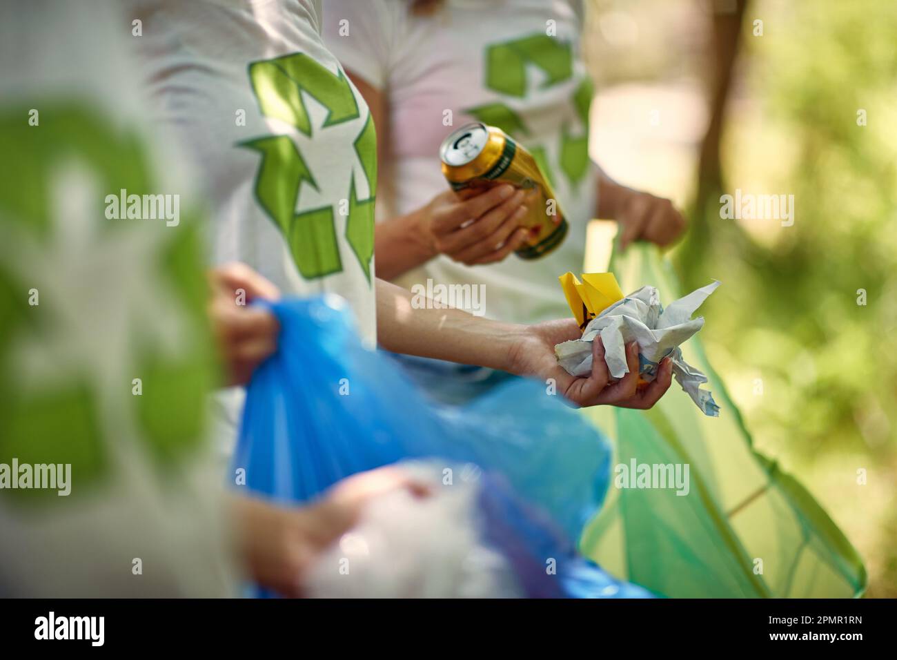 Closeup view of garbage being collected by young volunteers in the