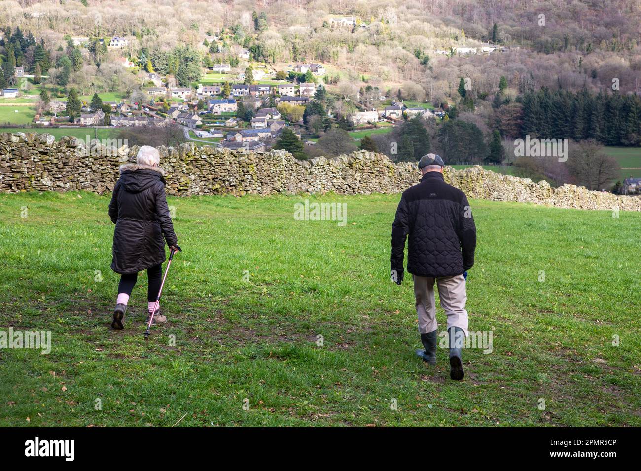 Elderly retired pensioners walking in the Derbyshire Peak District hills above the village of Froggott Stock Photo