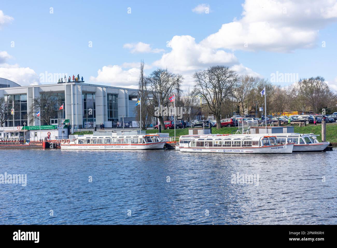 Musik und Kongresshalle (events venue) and river cruise boats across River Trave, Lübeck, Schleswig-Holstein, Federal Republic of Germany Stock Photo