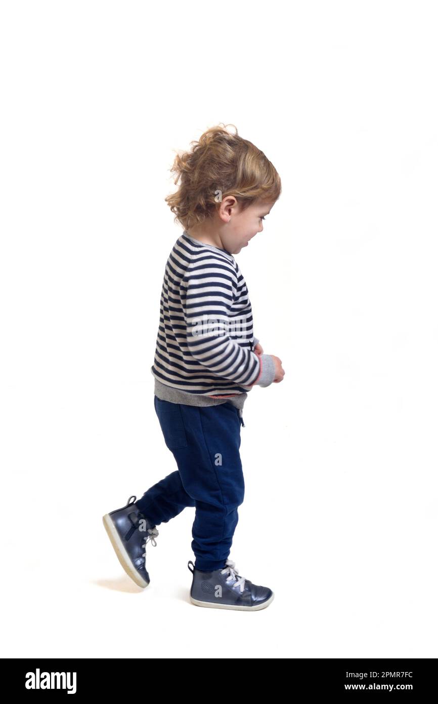 side view of a baby boy walking on white background Stock Photo Alamy