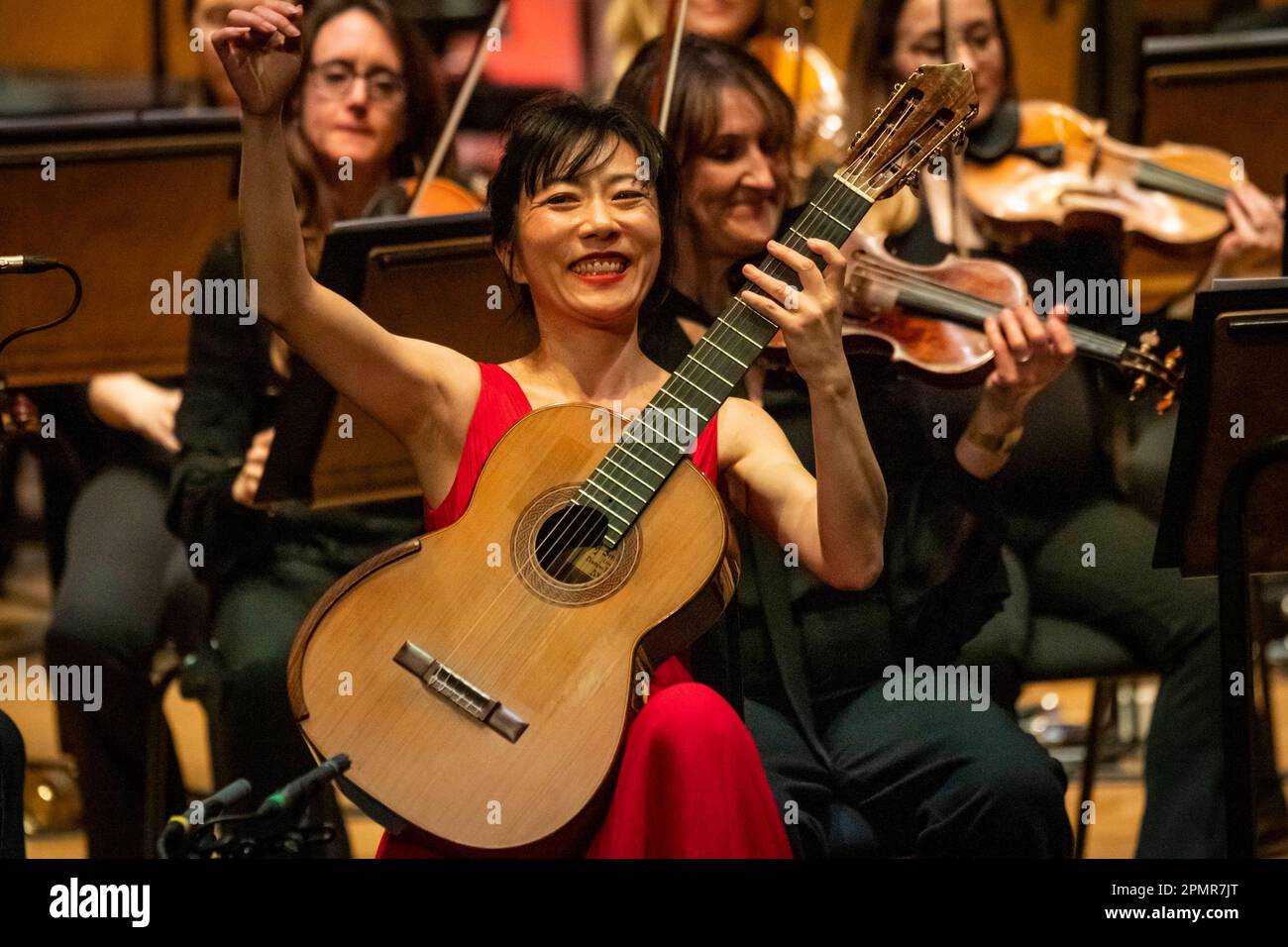 London, Britain. 13th Apr, 2023. Chinese guitarist Yang Xuefei (Front) performs during East Meets West concert in London, Britain, on April 13, 2023. The concert featuring Chinese and Western compositions was held in the Cadogan Hall here on Thursday evening. Credit: Stephen Chung/Xinhua/Alamy Live News Stock Photo