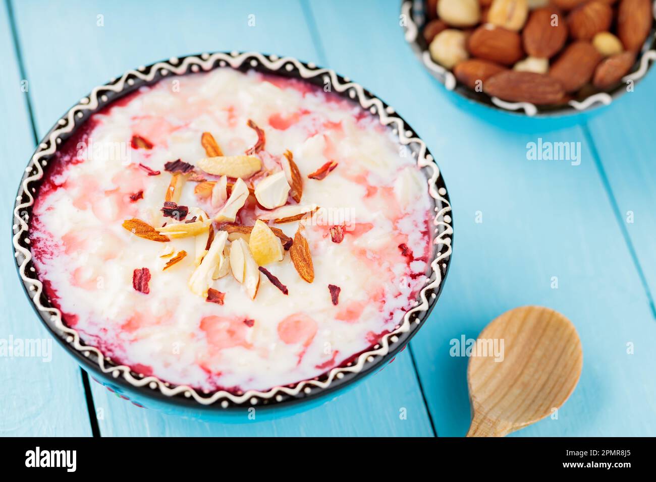 Palestinian Rice Pudding Delicious rice pudding with nuts and rose water. Bowl of indian kheer ...