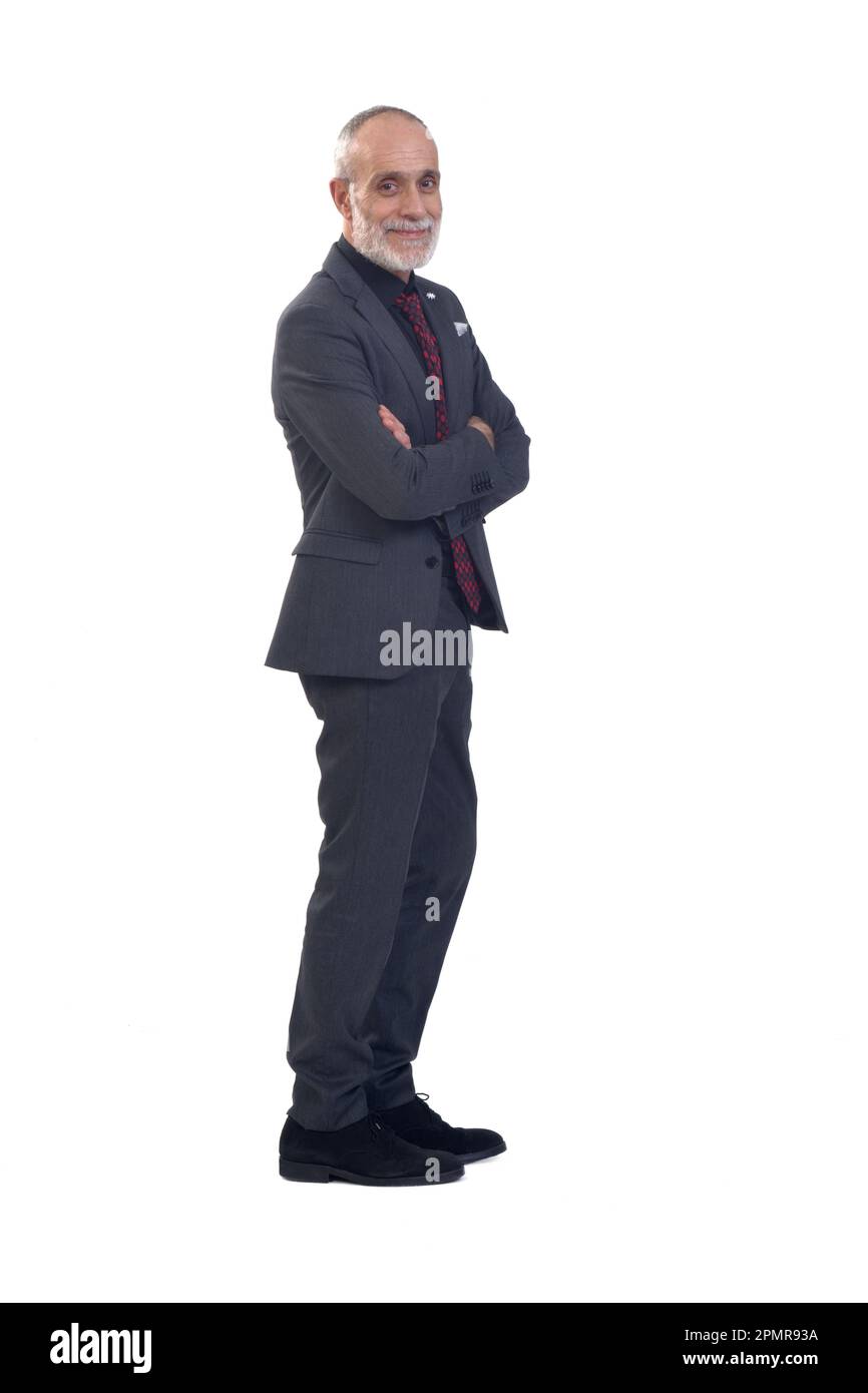 side view of a man with arms crossed and looking at camera on whte ...