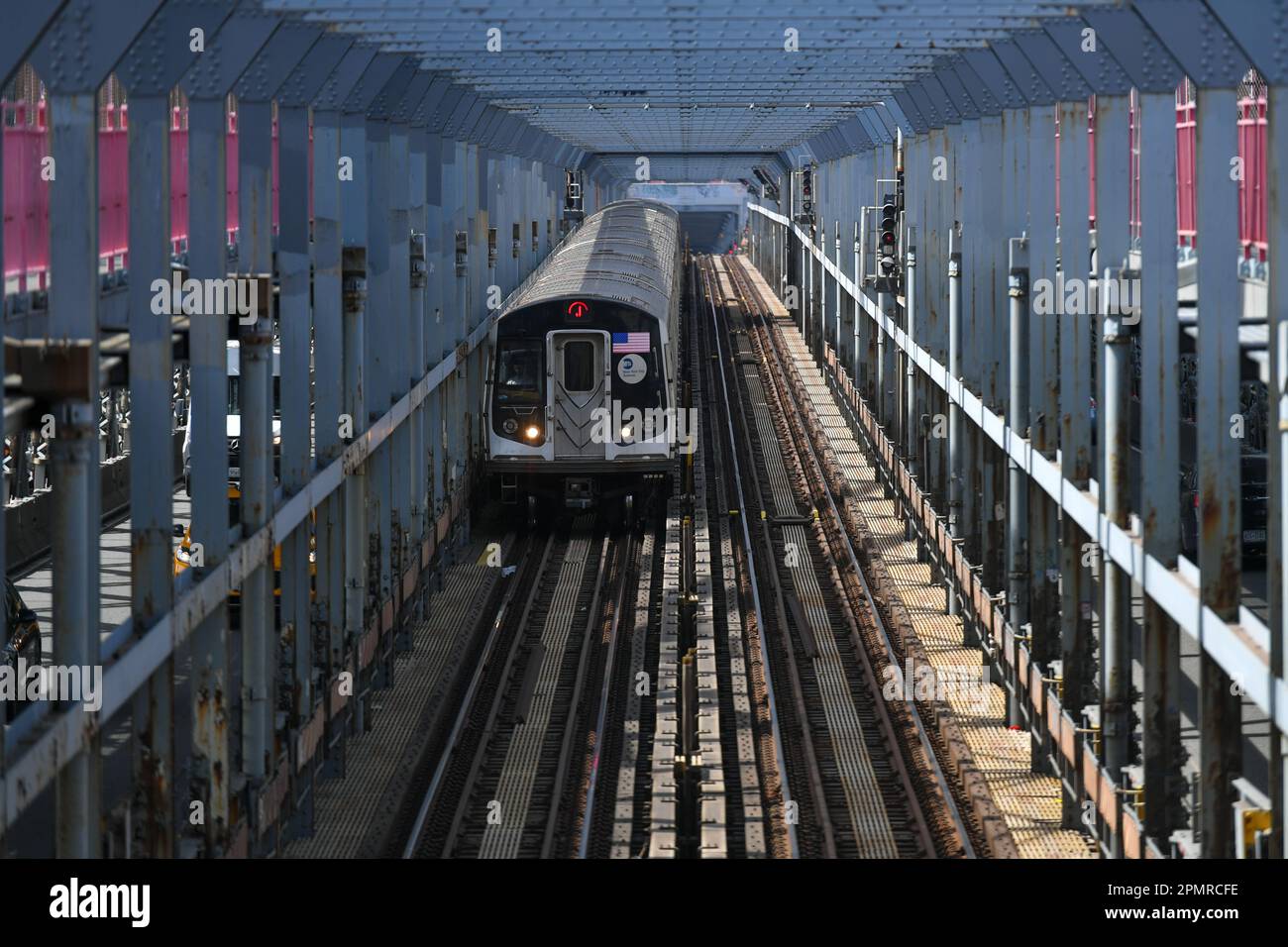 A subway train crosses over the Williamsburg Bridge on April 14, 2023 in New York City. Stock Photo