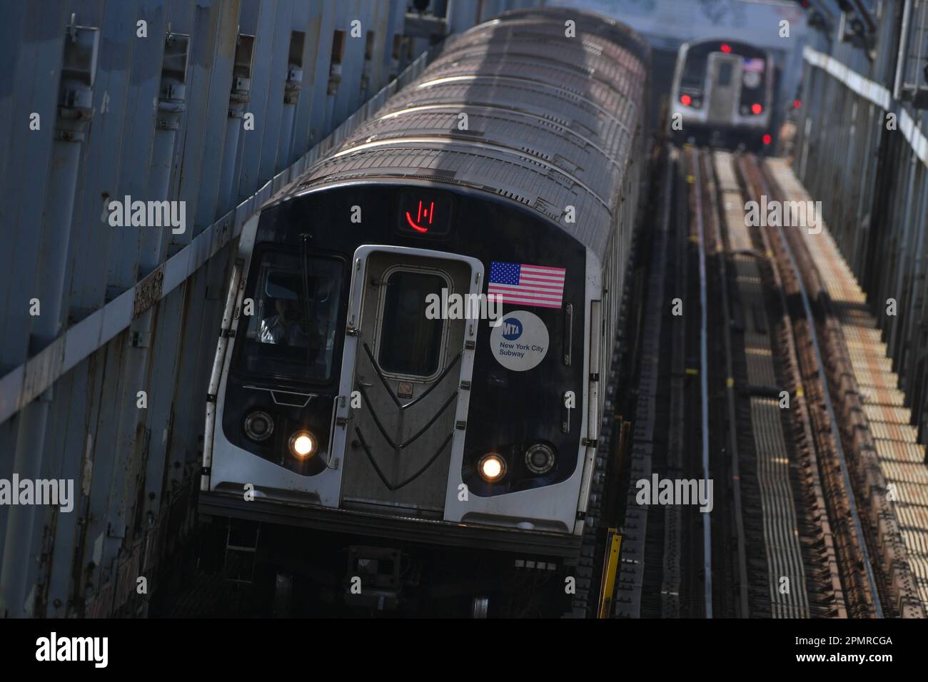 Two subway trains cross over the Williamsburg Bridge on April 14, 2023 in New York City. Stock Photo