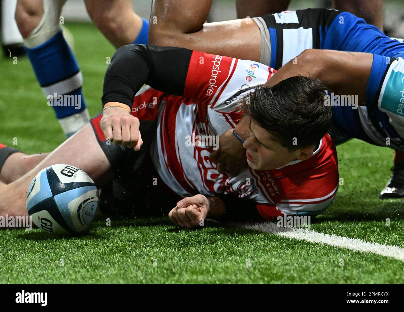Kingsholm Stadium, Gloucester, Gloucestershire, UK. 14th Apr, 2023. Gallagher Premiership Rugby, Gloucester versus Bath; Seb Atkinson of Gloucester scores a try under pressure from Ollie Lawrence of Bath in 45th minute bringing the score to 22-14 Credit: Action Plus Sports/Alamy Live News Stock Photo