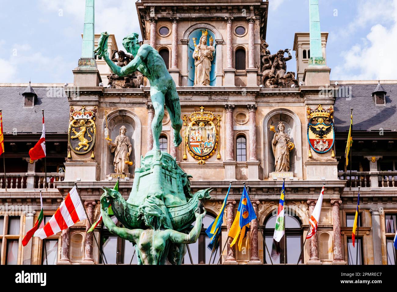 In the foreground, Silvius Brabo, a mythical Roman soldier who was said to have killed a giant, Druon Antigoon, and the City Hall of Antwerp, Renaissa Stock Photo