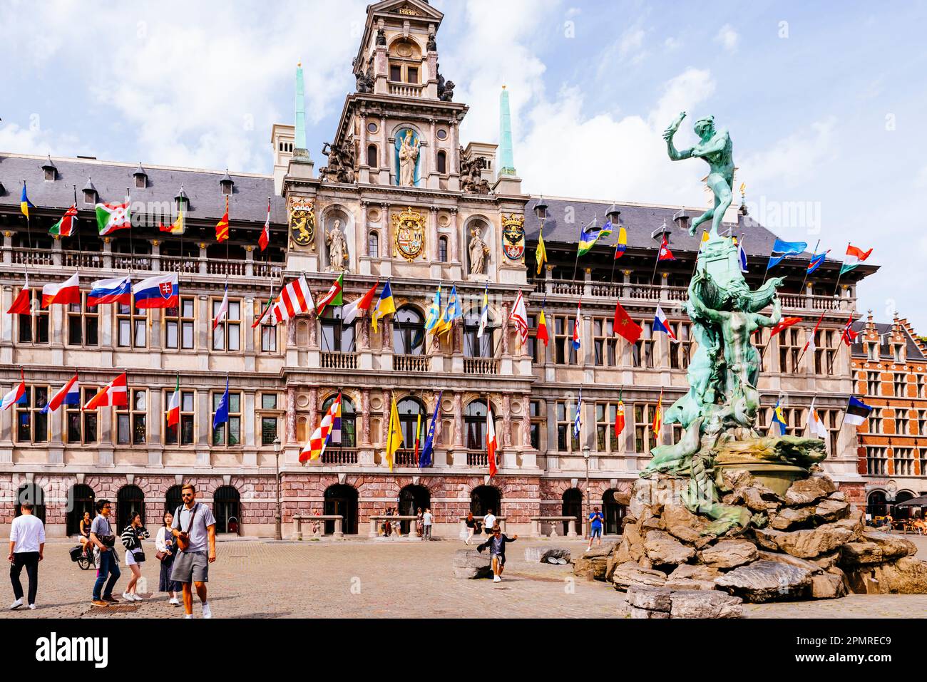 In the foreground, Silvius Brabo, a mythical Roman soldier who was said to have killed a giant, Druon Antigoon, and the City Hall of Antwerp, Renaissa Stock Photo