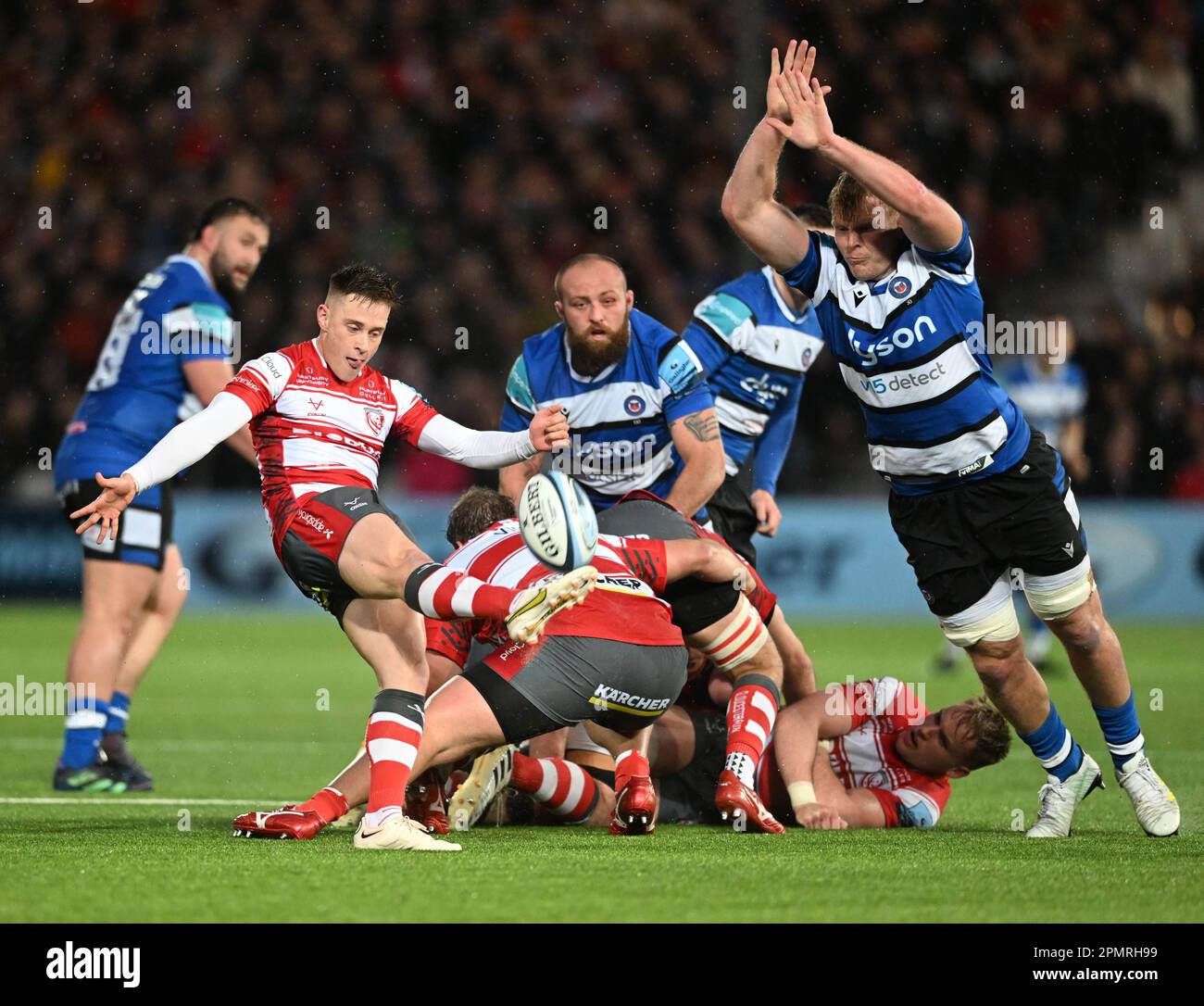 Kingsholm Stadium, Gloucester, Gloucestershire, UK. 14th Apr, 2023. Gallagher Premiership Rugby, Gloucester versus Bath; Steven Varney of Gloucester kicks from the base of the ruck under pressure from Josh McNally of Bath Credit: Action Plus Sports/Alamy Live News Stock Photo